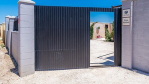 A gated entrance to a property with a sign indicating 'Casa Rural' and 'Casa Rafael.' - Holiday Home "Casa Rural Rafael" with Private Pool, Private Terraces & Wi-Fi (Lantejuela)