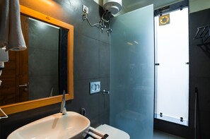 A modern bathroom with a large mirror, a sink, and a shower enclosure. - Moustache Bhimtal Luxuria, Nainital (Nainital)