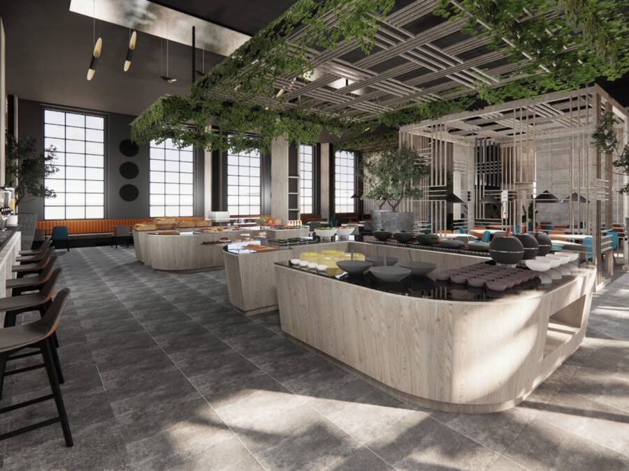 A modern interior with a central island, seating areas, and large windows.