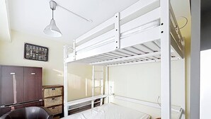 A bunk bed room with a desk, chair, and a wall-mounted shelf. - Ground Floor Apartment with Terrace, Near Shops, Sleeps 4 (Merville-Franceville-Plage)