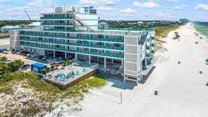 A modern hotel with multiple floors, a beach view, and a parking area. - FB Terrace Studio! Inquire for Monthly Rates (Panama City Beach)