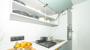 A modern kitchen with a built-in oven, a sink, and a fruit bowl on the counter. - Comfortable studio ski-in/out with balcony and WIFI (Tignes)
