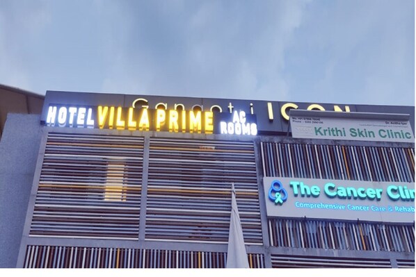 A hotel sign with "HOTEL VILLAPA PRIME AC ROOMS" and a clinic sign for "Krithi Skin Clinic" and "The Cancer Clinic".
