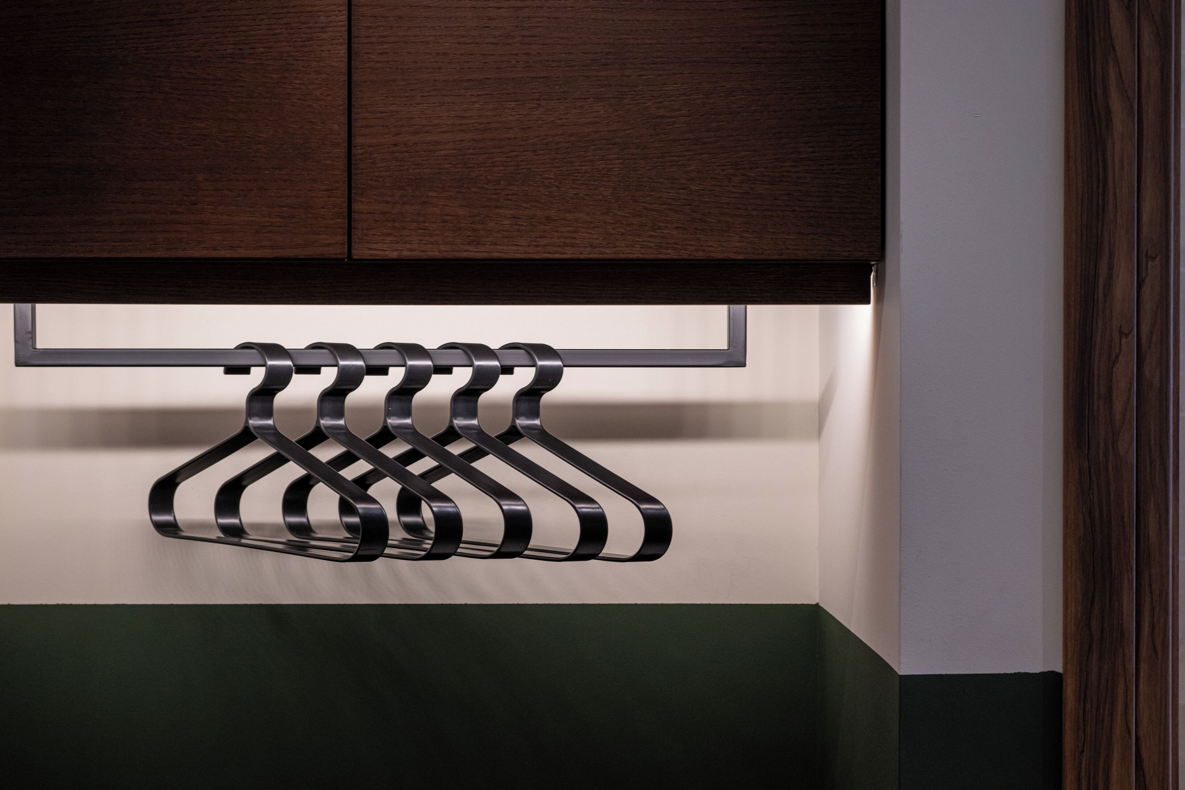 A wall-mounted rack with multiple hangers.