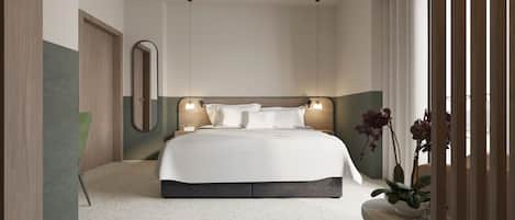 A modern hotel room with a large bed, a mirror, a bedside table, and a potted plant.