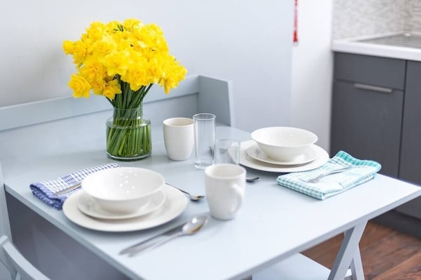 Enjoy meals in a stylish dining area with a white table set and modern decor.