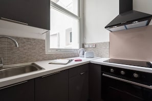 Enjoy cooking and meal preparation in this well-equipped kitchen with an oven and ample space.