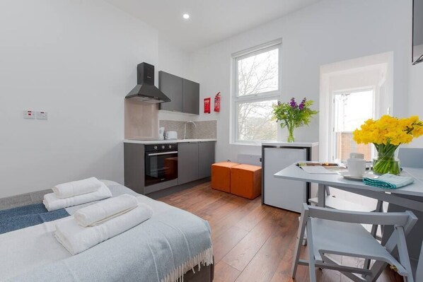 Enjoy a home away from home with a kitchenette, comfortable seating area, and a large window offering a view of the outside.