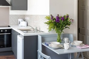 Efficient kitchen with dishwasher, sink, and toaster, perfect for meal preparation.