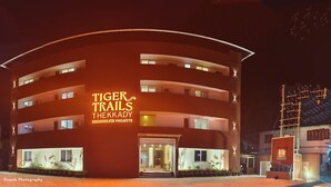 A multi-story building with illuminated signage reading "Tiger Trails Thekkady." - Tiger Trails Thekkady (Peermade)