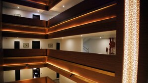 A multi-level interior with wooden paneling and recessed lighting. - Tiger Trails Thekkady (Peermade)