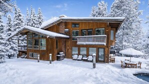 A wooden cabin with a balcony, snow-covered surroundings, and outdoor seating. - Ski-In/Ski-Out Snowmass Estate with Hot Tub, Fireplaces & Expansive Mountain Views (Snowmass Village)