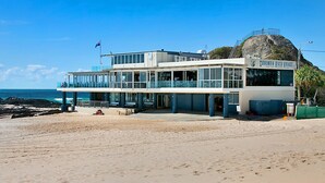 A beachfront building with a large balcony overlooking the ocean, named "Currumburra Beach Vikings." - Villa Paralia - Mediterranean Entertainers' Home in The Heart of Currumbin - Min. 3 Night Stays - (Currumbin)
