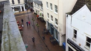 A narrow street with buildings on either side, a few pedestrians, and a sign for 'Superdrugs'. - Central Teignmouth - Sleeps 4 - Pets Allowed (Teignmouth)