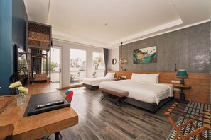 A hotel room with a large bed, a desk with a computer, a chair, and a view of the city through the window. - Hanoi Calido Hotel (Hanoi)