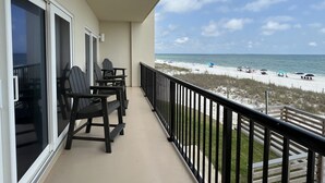 A balcony with black chairs and a view of the beach. - Wake Up to 1 Beautiful Vue - Beautiful Beachfront Condo! (Mexico Beach)