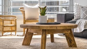 A round wooden table with a potted aloe vera plant, a candle, and a tray. - Welgelegen 608 (Cape Town)