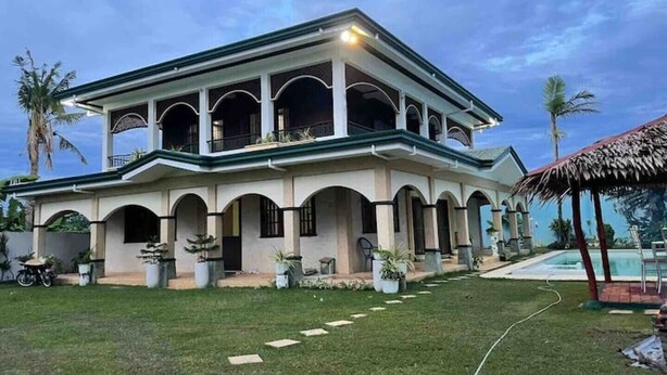A two-story house with a covered patio and a swimming pool. - House with private pool and extensive garden (Lapu-Lapu City,)