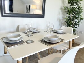 A 4-seater dining area typically features a dining table designed to comfortably accommodate four people.