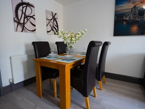 Enjoy meals in this dining area with a table for four, surrounded by comfortable seating and beautiful views.