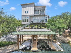 A two-story building with a covered dock area and a boat.