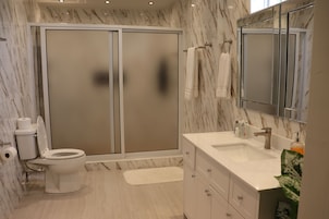 Apartamento família, 2 quartos, vista para o oceano | Banheiro | Chuveiro, chuveiro com efeito de chuva, produtos de toalete grátis