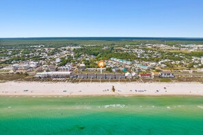 A coastal town with a beachfront hotel featuring multiple buildings, a sandy beach, and clear turquoise waters. - Beachfront Luxury Condo in Quiet Laguna Beach w/Amazing Views! Free Perks! (Panama City Beach)