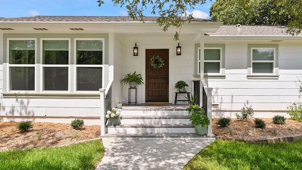 A white house with a front porch, steps, and potted plants. - Visiting professor?  New to area?  Perfect for you! (College Station)