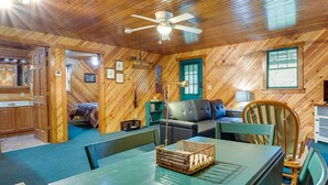 A cozy cabin interior with a dining table, chairs, a sofa, and a ceiling fan. - 2 Mi to Green Bank Observatory! Mtn-View Cabin (Green Bank)