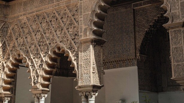 A historic building with intricate architectural details, including ornate arches and columns, and a balcony with balustrades. - Home2Book Amelia's Pottery, Triana (Sevilla)