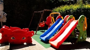 A playground with slides and climbing structures.