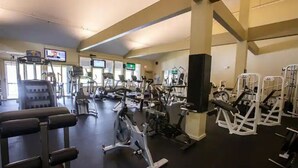 A gym with various exercise equipment, including treadmills, stationary bikes, and weight machines. - Ski, RIde, Walk On/Off Condo On Pico at Killington
 (Killington)