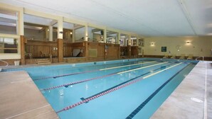 A large indoor swimming pool with multiple lanes, wooden paneling, and a tiled floor. - Ski, RIde, Walk On/Off Condo On Pico at Killington
 (Killington)