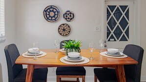 A dining table set with plates, glasses, and a centerpiece.