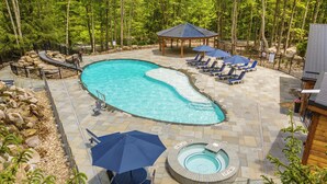 A pool area with a hot tub, lounge chairs, and a gazebo. - Gathering Place: Lakefront w. boat slip | Dog friendly | Hot tub | Fire pit (Oakland)
