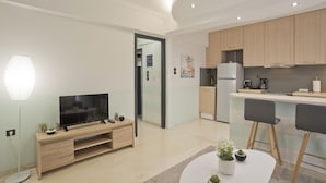 A modern apartment with a living room, kitchen, and dining area.