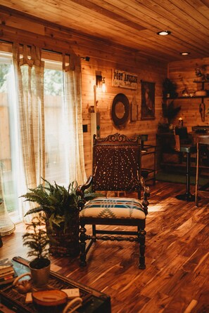 A wooden interior with a vintage chair, a sign reading "Port Angeles," and a rustic decor. - Woodland Bluff (Port Angeles)