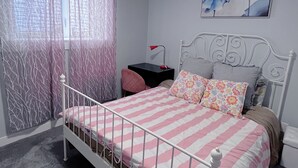 A bedroom with a bed, a desk, a chair, a window with curtains, and a painting on the wall. - Calgary elegant single room &shared bathroom close LRT&free parking (Calgary)