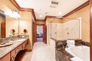 A spacious bathroom with a large vanity, a separate shower area, and a bathtub.