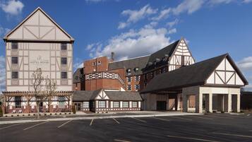 Un hotel de estilo arquitectónico tradicional, que destaca por una torre imponente y varios edificios con tejados diferenciados.
