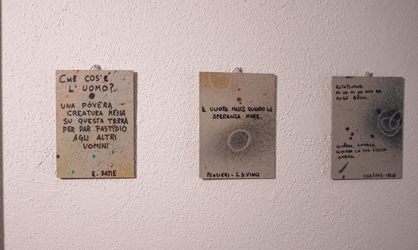 Three signs on a wall.