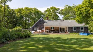 A two-story house with a large front lawn, a covered patio, and a swimming pool. - Springs / Amagansett area. Walk to bay. Private / 4 bedrooms  (East Hampton)