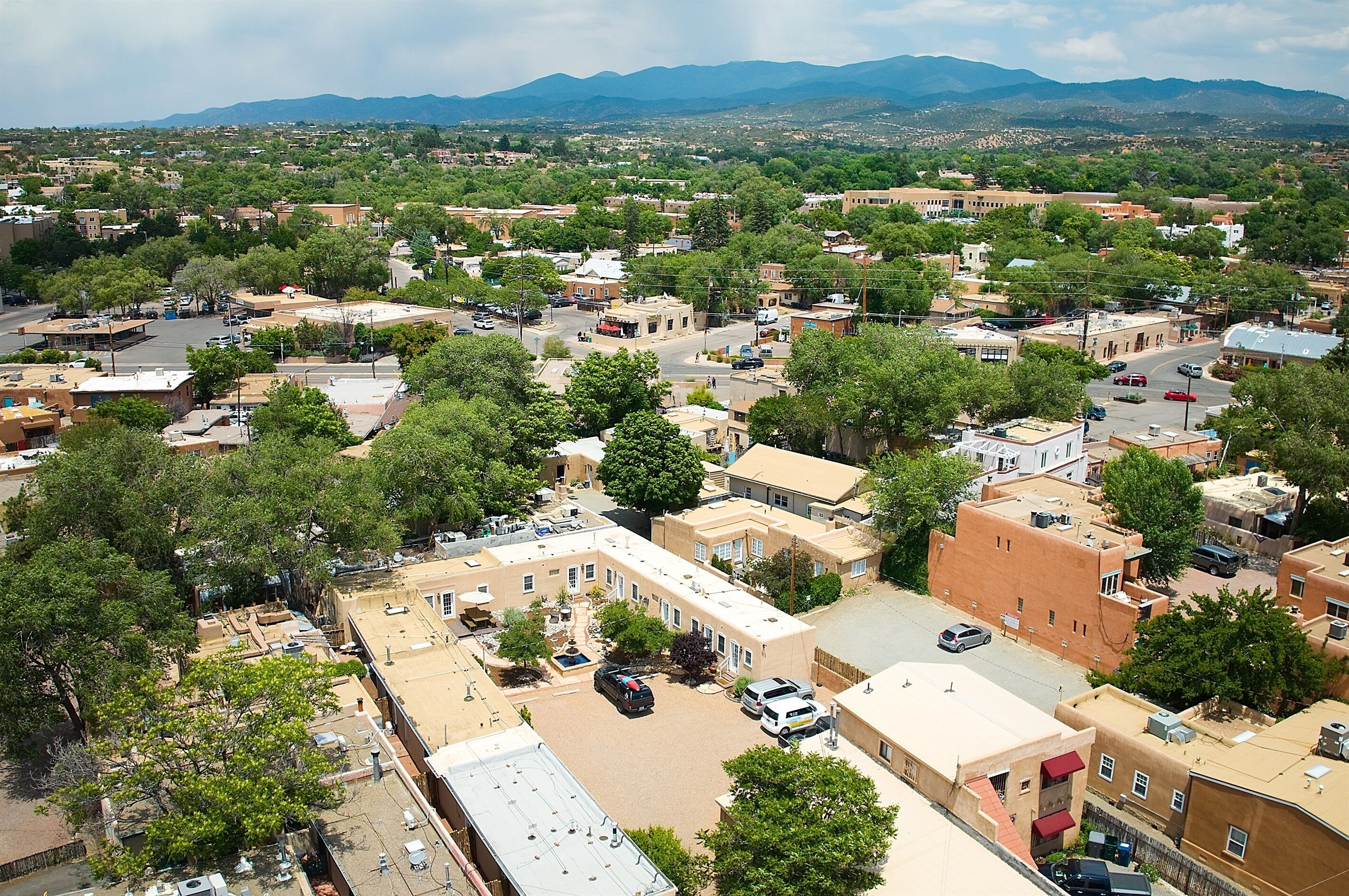 An aerial view of a town with buildings, streets, and trees.