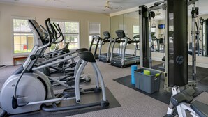 A gym with treadmills, ellipticals, and weight machines.
