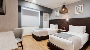 A hotel room with two beds, a desk, and a chair. - HS HOTSSON Acapulco Villas (Acapulco)