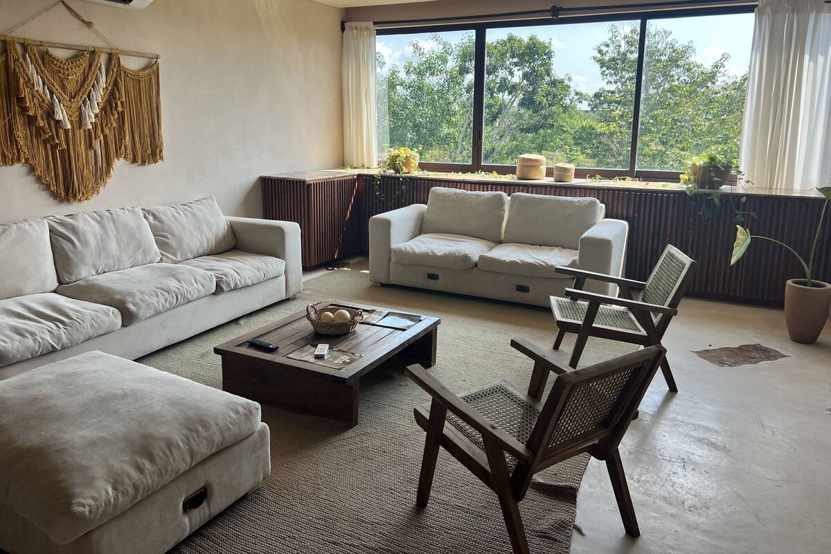 A modern living room with a sofa, armchair, and coffee table.