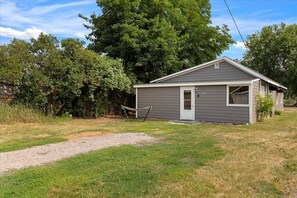 Situated in a serene natural setting, this cabin features a front door and a small window, perfect for a peaceful retreat.