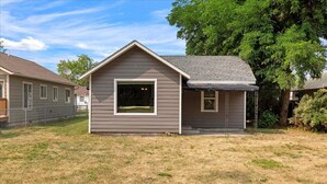 A small, single-story house with a gabled roof and a covered porch. - Cozy Cowboy Cabin in Polson: Historic Charm, Modern Comfort Near Flathead Lake (Polson)