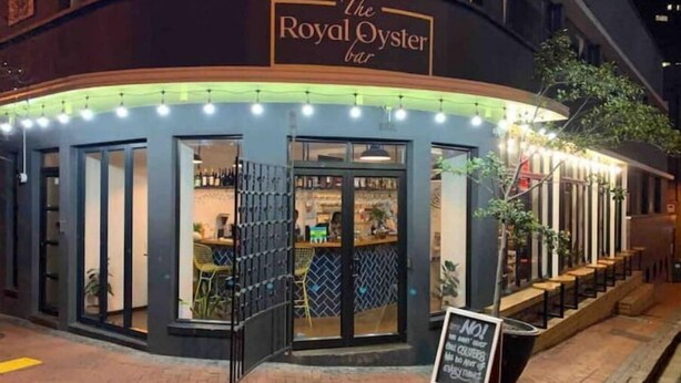 Royal Oyster Bar -niminen ravintola, jossa on ulkona oleva istuma-alue ja kyltti.