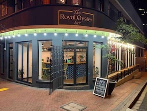 The Royal Oyster Bar with an outdoor seating area and a signboard.